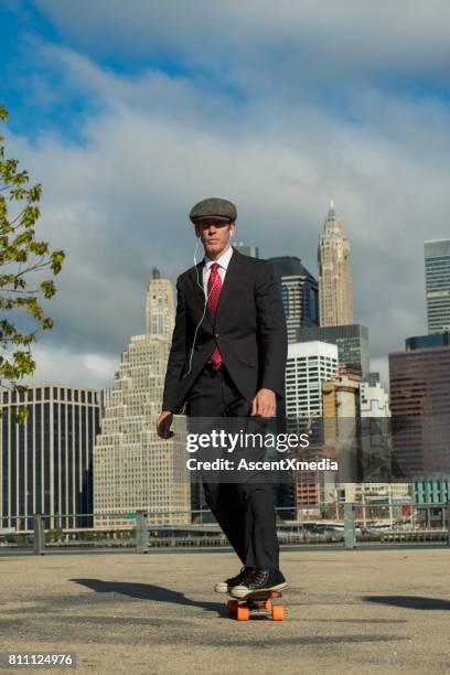 businessman skateboarding in new york - wall street man stock pictures, royalty-free photos & images