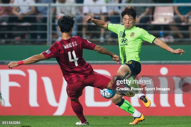 Shanghai SIPG FC defender Wang Shenchao fights for the ball with Jeonbuk Hyundai Motors FC midfielder Kim Bo Kyung during the AFC Champions League...