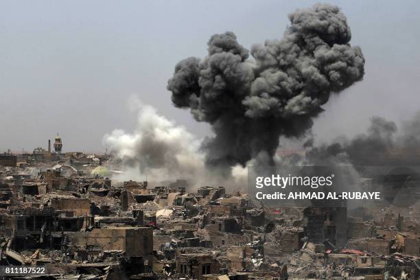 Picture taken on July 9 shows smoke billowing following an airstrike by US-led international coalition forces targeting Islamic State group in Mosul....