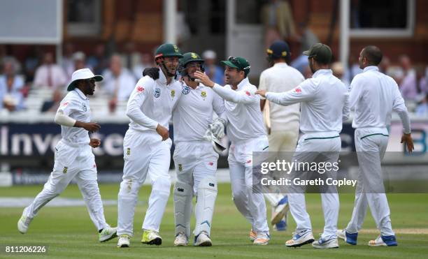 Theunis de Bruyn of South Africa celebrates with teammates after catching out Stuart Broad of England during the 4th day of the 1st Investec Test...