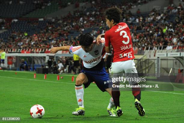 Kisho Yano of Albirex Niigata and Tomoya Ugajin of Urawa Red Diamonds compete for the ball during the J.League J1 match between Urawa Red Diamonds...