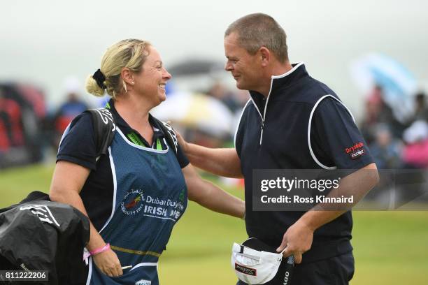 David Drysdale of Scotland completes his round on the 18th green with wife / caddie Vicky during the final round of the Dubai Duty Free Irish Open at...