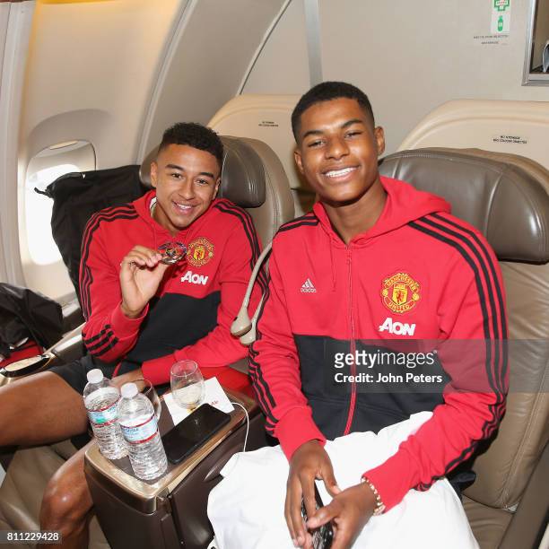 Jesse Lingard and Marcus Rashford sit on the aeroplane ahead of the club's pre-season tour of the USA at Manchester Airport on July 9, 2017 in...