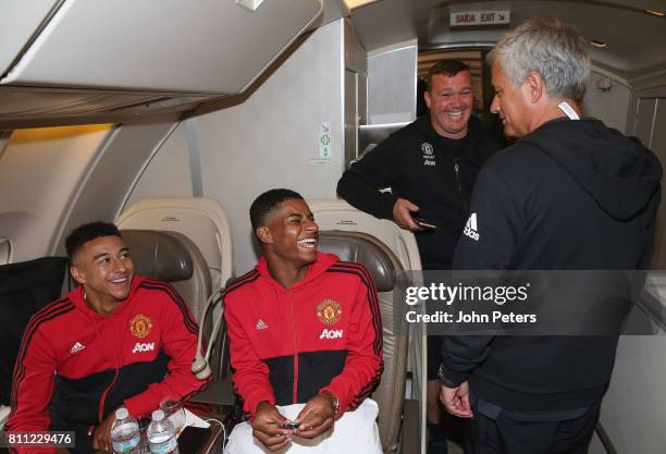 Manager Jose Mourinho, Jesse Lingard and Marcus Rashford sit on the aeroplane ahead of the club's pre-season tour of the USA at Manchester Airport on...