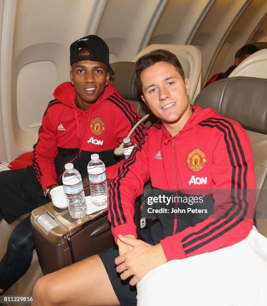 Ashley Young and Ander Herrera of Manchester United sit on the aeroplane ahead of the club's pre-season tour of the USA at Manchester Airport on July...