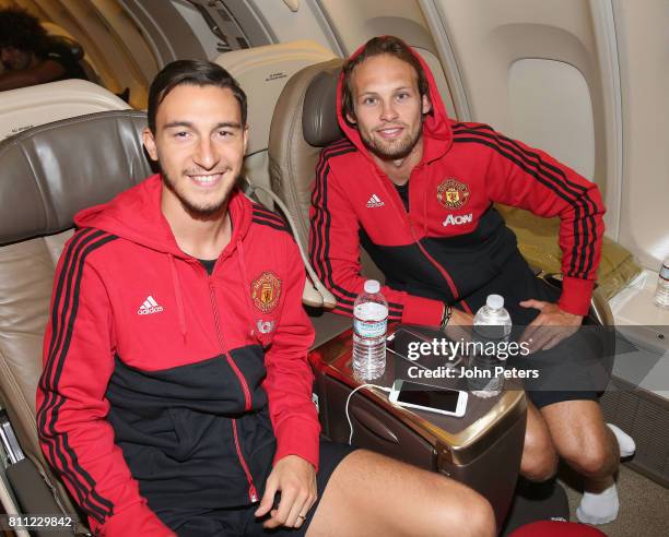 Matteo Darmian and Daley Blind of Manchester United sit on the aeroplane ahead of the club's pre-season tour of the USA at Manchester Airport on July...