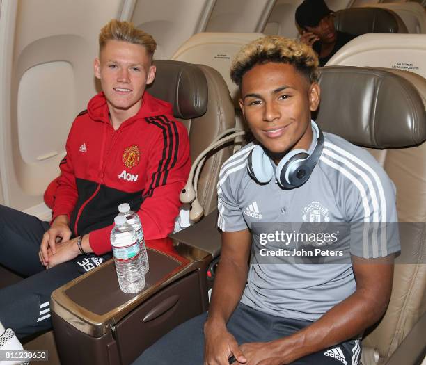 Scott McTominay and Demitri Mitchell of Manchester United sits on the aeroplane ahead of the club's pre-season tour of the USA at Manchester Airport...