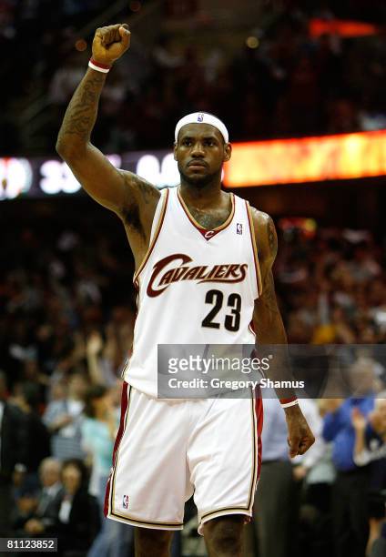 LeBron James of the Cleveland Cavaliers reacts after teammate Delonte West made a 3-point shot at the buzzer at the end of the second quarter to give...