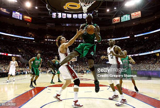 Keivn Garnett of the Boston Celtics grabs a rebound against Anderson Varejao and Joe Smith of the Cleveland Cavaliers in Game Six of the Eastern...