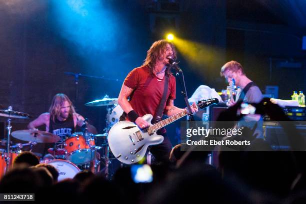Taylor Hawkins, Dave Grohl and Nate Mendel of Foo Fighters performing at Stubb's at the opening of their documentary, 'Foo Fighters: Back and Forth,'...