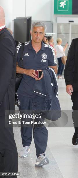 Manager Jose Mourinho of Manchester United checks in at Manchester Airport ahead of the club's pre-season tour of the USA at Manchester Airport on...
