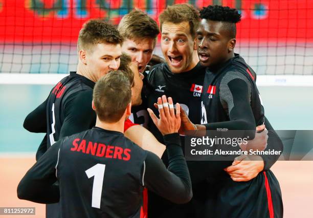 Players of Canada celebrate after winning the bronze medal match against the United States at Arena da Baixada Stadium during day five of the FIVB...