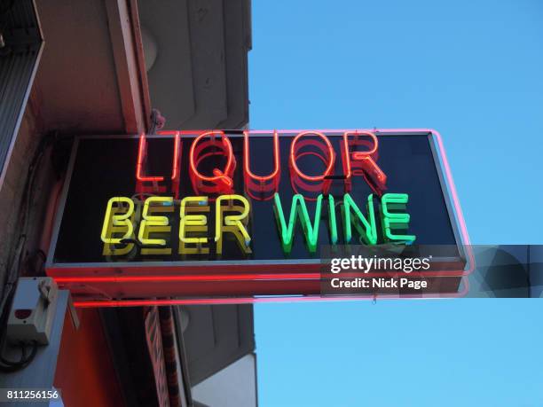 neon shop sign advertising liquor, beer and wine - beer advertisement stock pictures, royalty-free photos & images