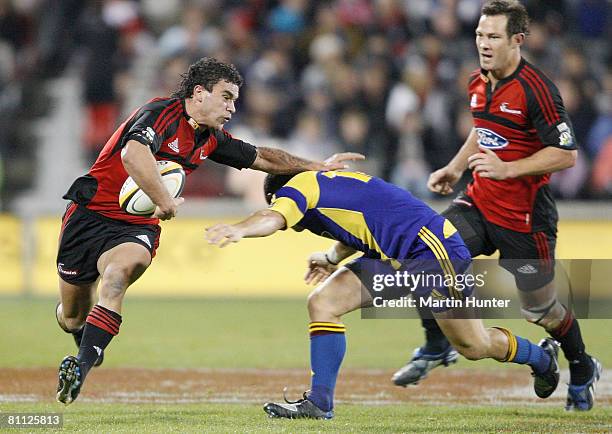 Kade Poki of the Crusaders is tackled by Mike Delany of the Highlanders during the round 14 Super 14 match between the Crusaders and the Highlanders...