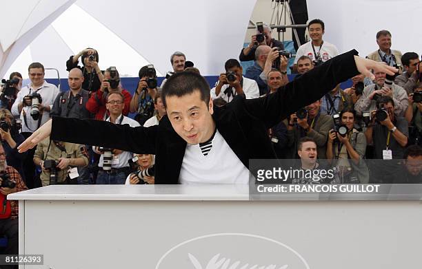 Chinese director Jia Zhang Ke gestures as she poses during a photocall for his film '24 City' at the 61st Cannes International Film Festival on May...