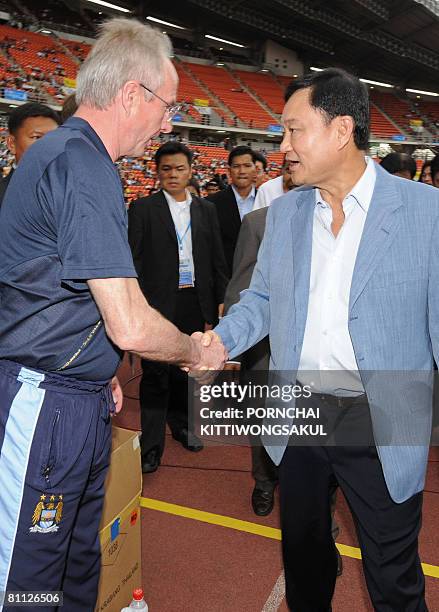 Manchester City owner Thaksin Shinawatra shakes hands with team manager Sven-Goran Eriksson at a friendly match opposing the British Premiere League...