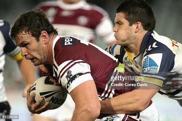 Josh Perry of the Sea Eagles is tackled during the round 10 NRL match between the Manly Warringah Sea Eagles and the North Queensland Cowboys at...