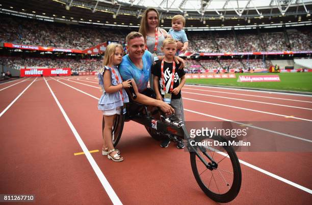 David Weir of Great Britain poses for a photo with his family after winning the mens T54 800m race which will be last event before he retires during...