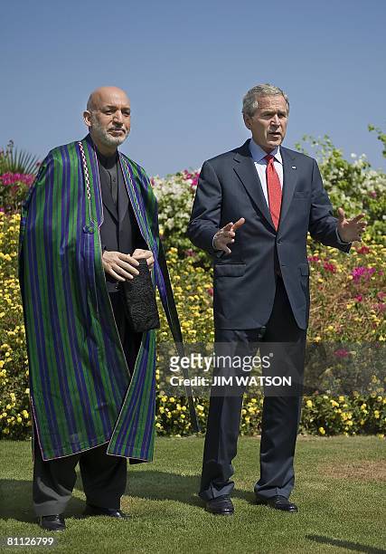 President George W. Bush speaks with his Afghan counterpart Hamid Karzai after a bilateral meeting in the Egyptian Red Sea resort of Sharm El-Sheikh...