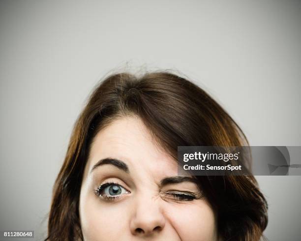 close up of beautiful young woman winking - fat woman funny imagens e fotografias de stock