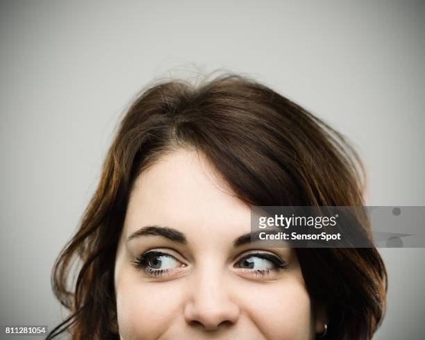real young happy woman looking to the side - sideways glance stock pictures, royalty-free photos & images