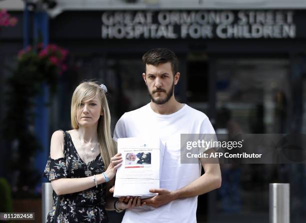 Connie Yates and Chris Gard, parents of terminally-ill 10-month-old Charlie Gard, pose with a petition of signatures supporting their case, prior to...