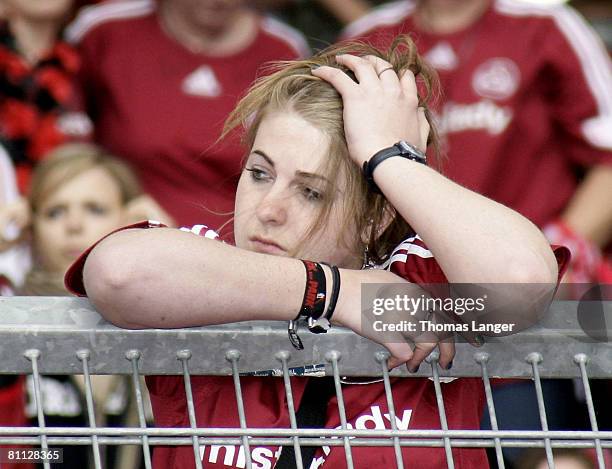 Fan of Nuremberg looks dejected after the Bundesliga match between 1. FC Nuernberg and FC Schalke 04 at the Easy Credit stadium on May 17, 2008 in...