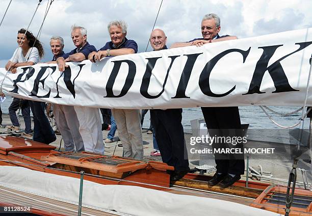 Former team-mates of French sailing legend late Eric Tabarly and his daughter Marie Tabarly pose aboard Tabarly's first monohull 'Pen Duick I' during...