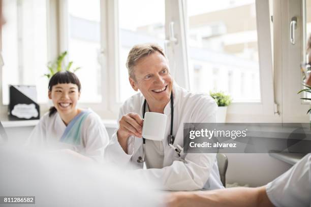 medics enjoying coffee during work break - nurse resting stock pictures, royalty-free photos & images