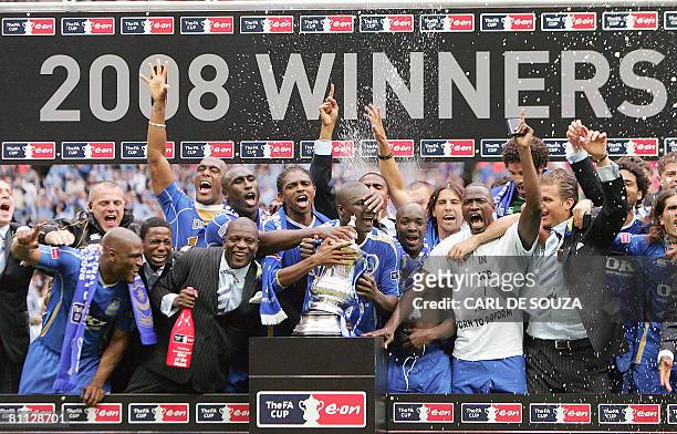 The Portsmouth team celebrate with the FA Cup trophy after their FA Cup final match against Cardiff City at Wembley football Stadium, London on May...