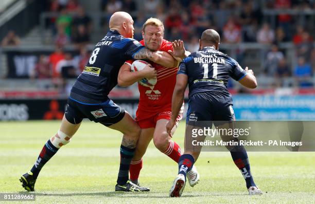 Salford Red Devils' Josh Jones is tackled by Leeds Rhinos Keith Galloway and Jamie Jones-Buchanan , during the Betfred Super League match at the AJ...