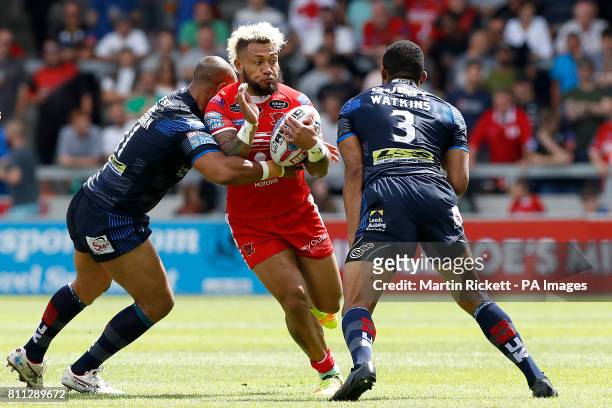 Salford Red Devils' Junior Sa'u is tackled by Leeds Rhinos Jamie Jones-Buchanan and Callum Watkins , during the Betfred Super League match at the AJ...