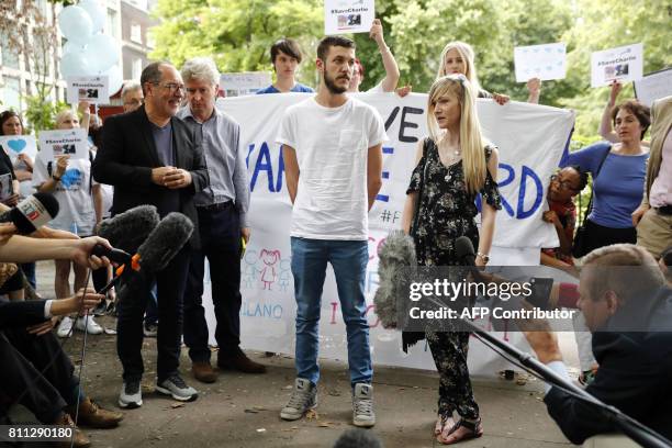 Connie Yates and Chris Gard, , parents of terminally-ill 10-month-old Charlie Gard, are surrounded by supporters prior to delivering a petition of...