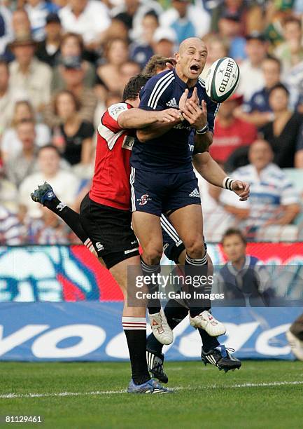 Conrad Jantjes of the Lions goes for the high ball & is tackled by Jaque Fourie of the Lions during the Super 14 match between Lions and the...