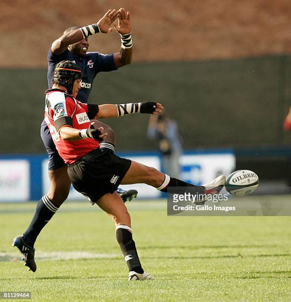 Earl Rose kicks for the Lions while Gcobani Bobo of the Stormers tries to charge the kick down during the Super 14 match between Lions and the...