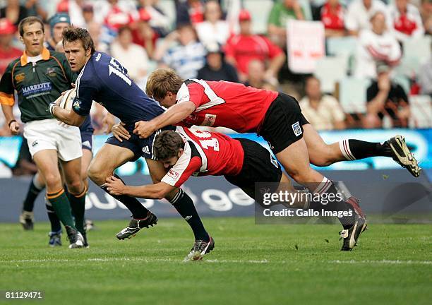 Peter Grant is double tackled by & Jaco van Schalkwyk of the Lions during the Super 14 match between Lions and the Stormers. The game was won 22-13...