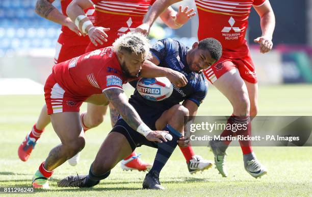 Leeds Rhinos Kallum Watkins is tackled by Salford Red Devils' Junior Sa'u, resulting in Watkins receiving treatment and Sa'u receiving a yellow card,...