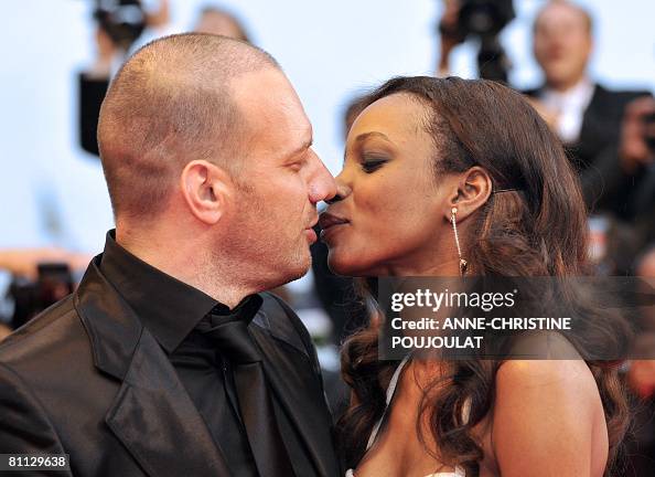 French actor Samuel Le Bihan and his wife Daniela Beye kiss as they ...