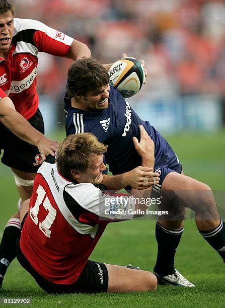 Schalk Brits is brought down by Ross Geldenhuys of the Lions during the Super 14 match between Lions and the Stormers. The game was won 22-13 by the...