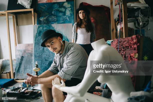 portrait of woman and man  in art studio - art modeling studio stock pictures, royalty-free photos & images