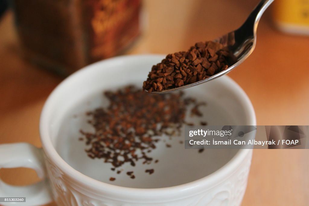 Ground coffee putting in milk