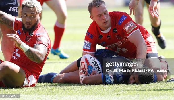 Leeds Rhinos Kallum Watkins lies injured after a tackle from Salford Red Devils' Junior Sa'u , resulting in Watkins receiving treatment and Sa'u...