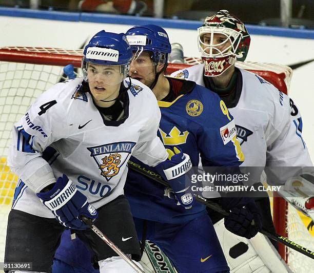 Finland Ville Koistinen and goalie Niklas Backstrom block out Sweden's Tony Martensson in the 2nd period during the bronze medal game of the 2008...