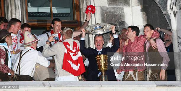 Ottmar Hitzfeld, head coach of Bayern Munich and his players celebrate with the Bundesliga champions trophy and the DFB Cup trophy during the Bayern...