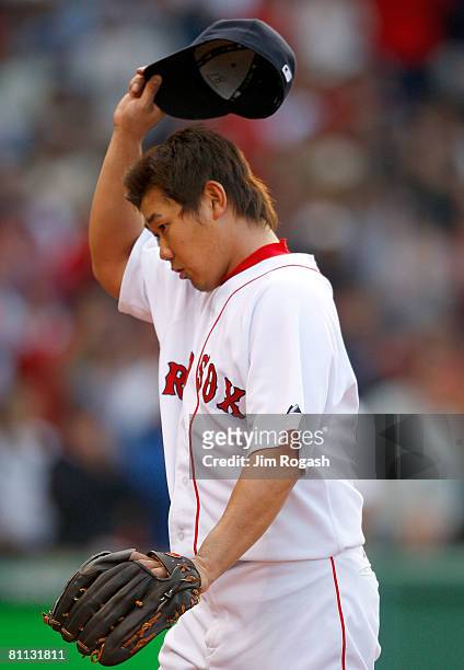 Daisuke Matsuzaka of the Boston Red Sox reacts to fans in the seventh inning during a game against the Milwaukee Brewers in the first inning at...