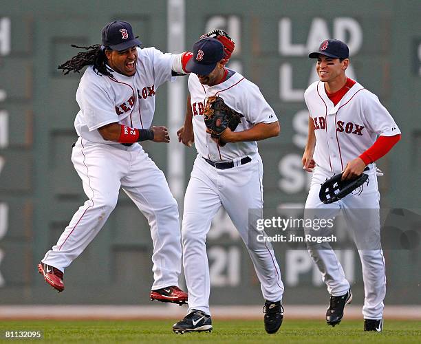 Manny Ramirez of the Boston Red Sox celebrates with teammates Alex Corra, who made the final put-out, and Jacoby Ellsbury after defeating Milwaukee...