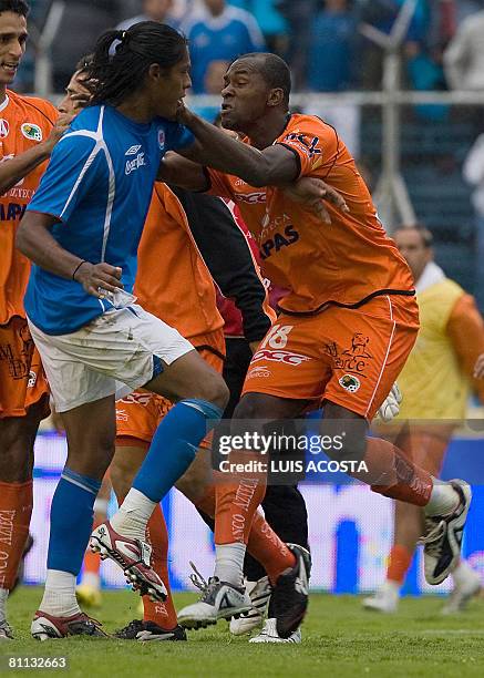 Jaguares' Itamar Batista pushes Cruz Azul's Joel Huiqui during their Mexican league football quarter-final match in Mexico City on May 17, 2008. Cruz...