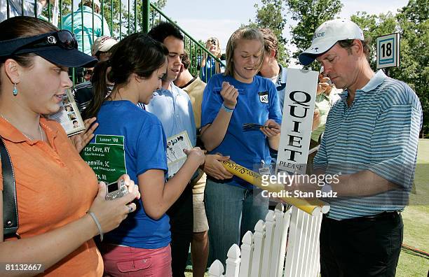 Actor Greg Kinnear, right, signs autographs for fans during the third round of the BMW Charity Pro-Am at Thornblade Club held on May 17, 2008 in...