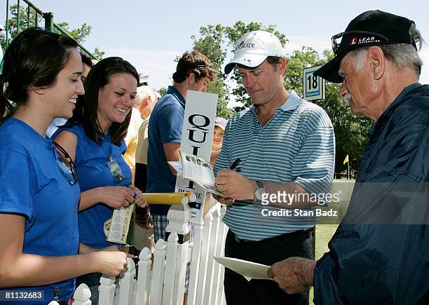 Actor Greg Kinnear, center, signs autographs for fans during the third round of the BMW Charity Pro-Am at Thornblade Club held on May 17, 2008 in...