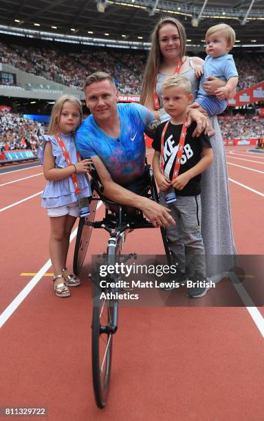 David Weir of Great Britain poses for a photo with his family after winning the mens T54 800m race which will be last event before he retires during...